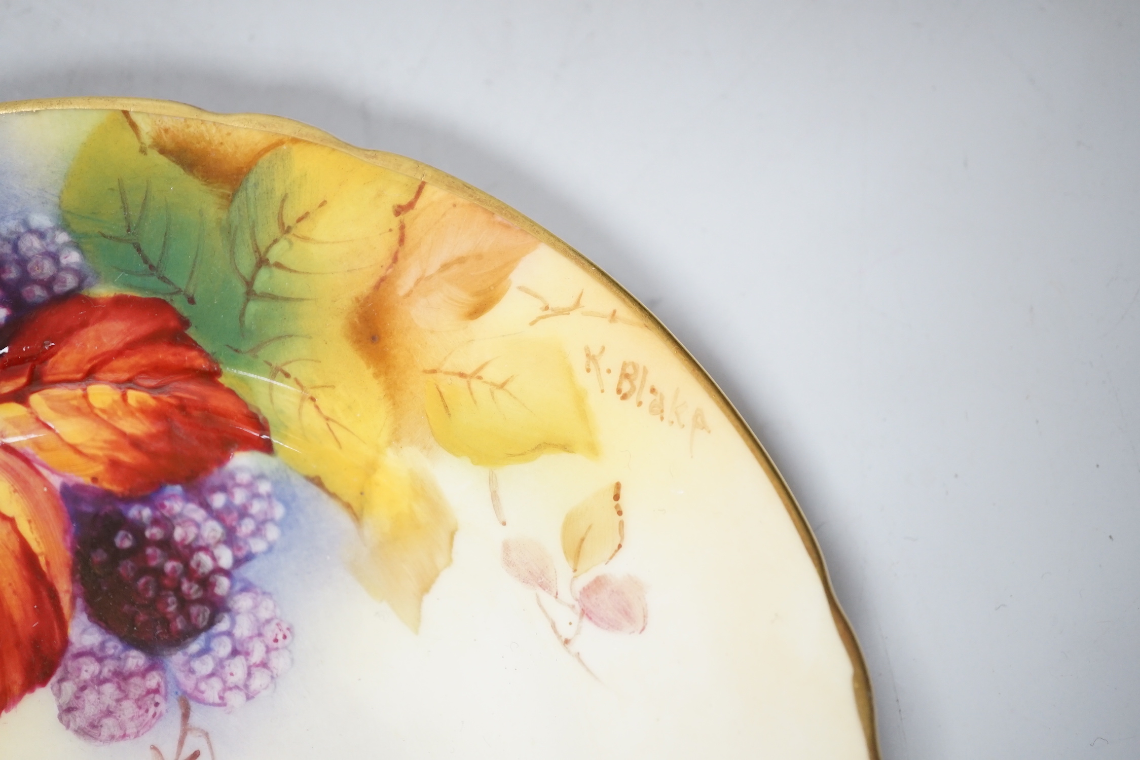 A pair of Royal Worcester lobed tea plates painted with autumnal leaves and berries by Kitty Blake, signed date mark 1935
